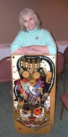 Image # 53371: Sorcerer Artist and Playfield 
(Artist Pam Erickson at Chicago Pinball Expo 2004.)